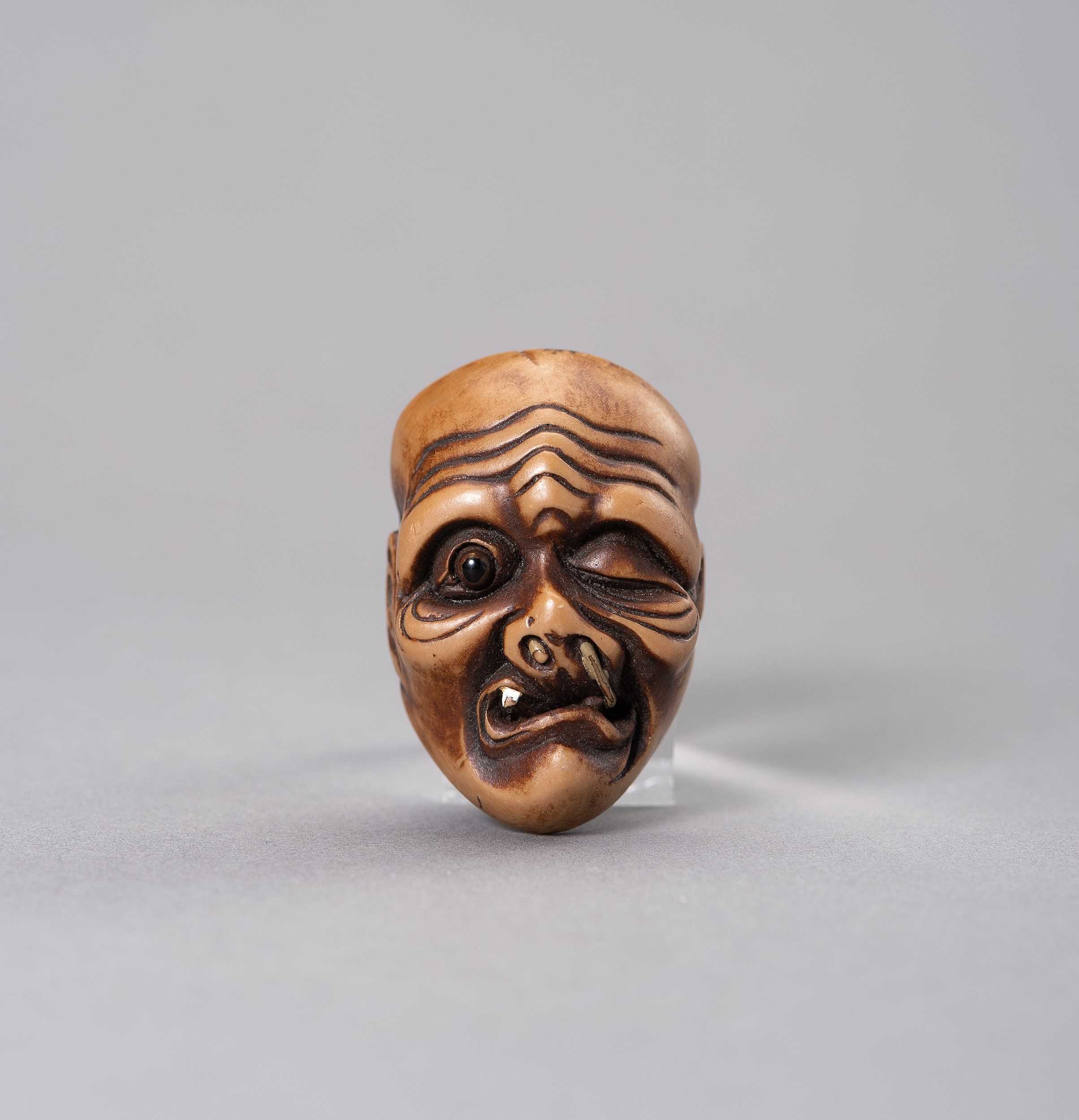 Lot 500 - A VEGETABLE IVORY MASK OF AN OLD MAN
