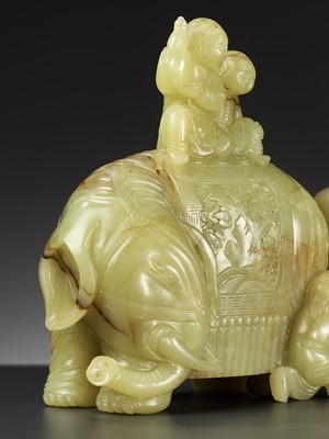 Lot 447 - A YELLOW AND RUSSET JADE ‘ELEPHANT AND BOYS’ GROUP, 18TH CENTURY