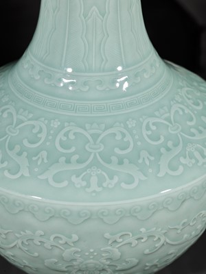 Lot 81 - A CARVED CELADON-GLAZED ‘LOTUS’ VASE, QIANLONG MARK AND PERIOD