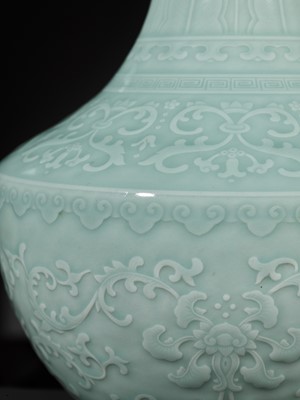 Lot 81 - A CARVED CELADON-GLAZED ‘LOTUS’ VASE, QIANLONG MARK AND PERIOD