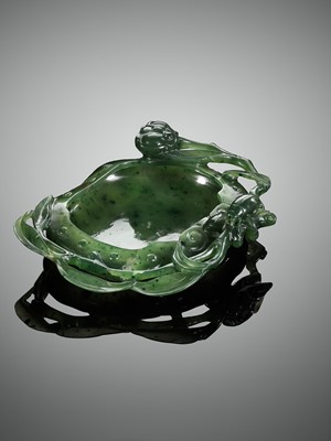 Lot 461 - A SPINACH-GREEN JADE ‘BEETLE AND LOTUS’ WASHER, QING DYNASTY