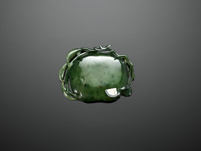 Lot 461 - A SPINACH-GREEN JADE ‘BEETLE AND LOTUS’ WASHER, QING DYNASTY