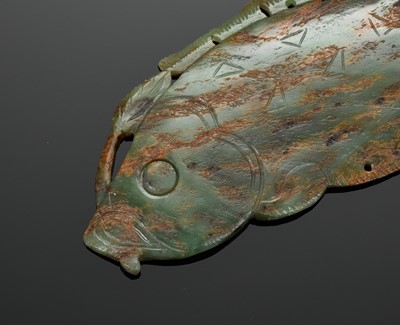Lot 435 - A GREEN AND BROWN JADE FISH-FORM PENDANT, SHANG TO WESTERN ZHOU DYNASTY