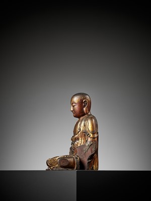 Lot 388 - A GILT-LACQUERED WOOD FIGURE OF A LUOHAN, MING DYNASTY