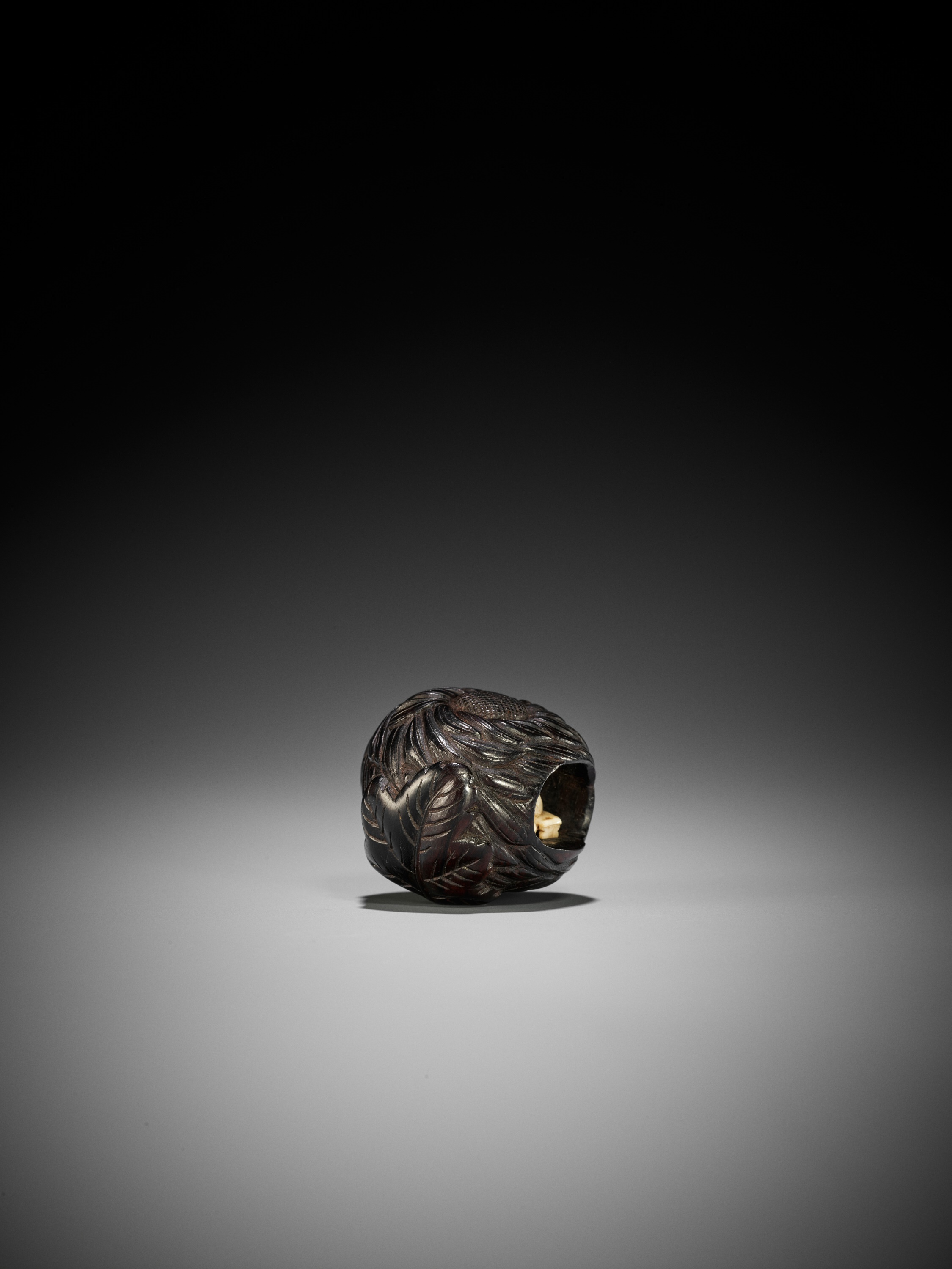Lot 210 - KAGETOSHI: A FINE INLAID EBONY WOOD NETSUKE