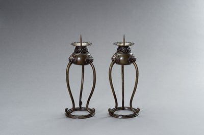 Lot 54 - A PAIR OF BRONZE CANDLE STICK HOLDERS