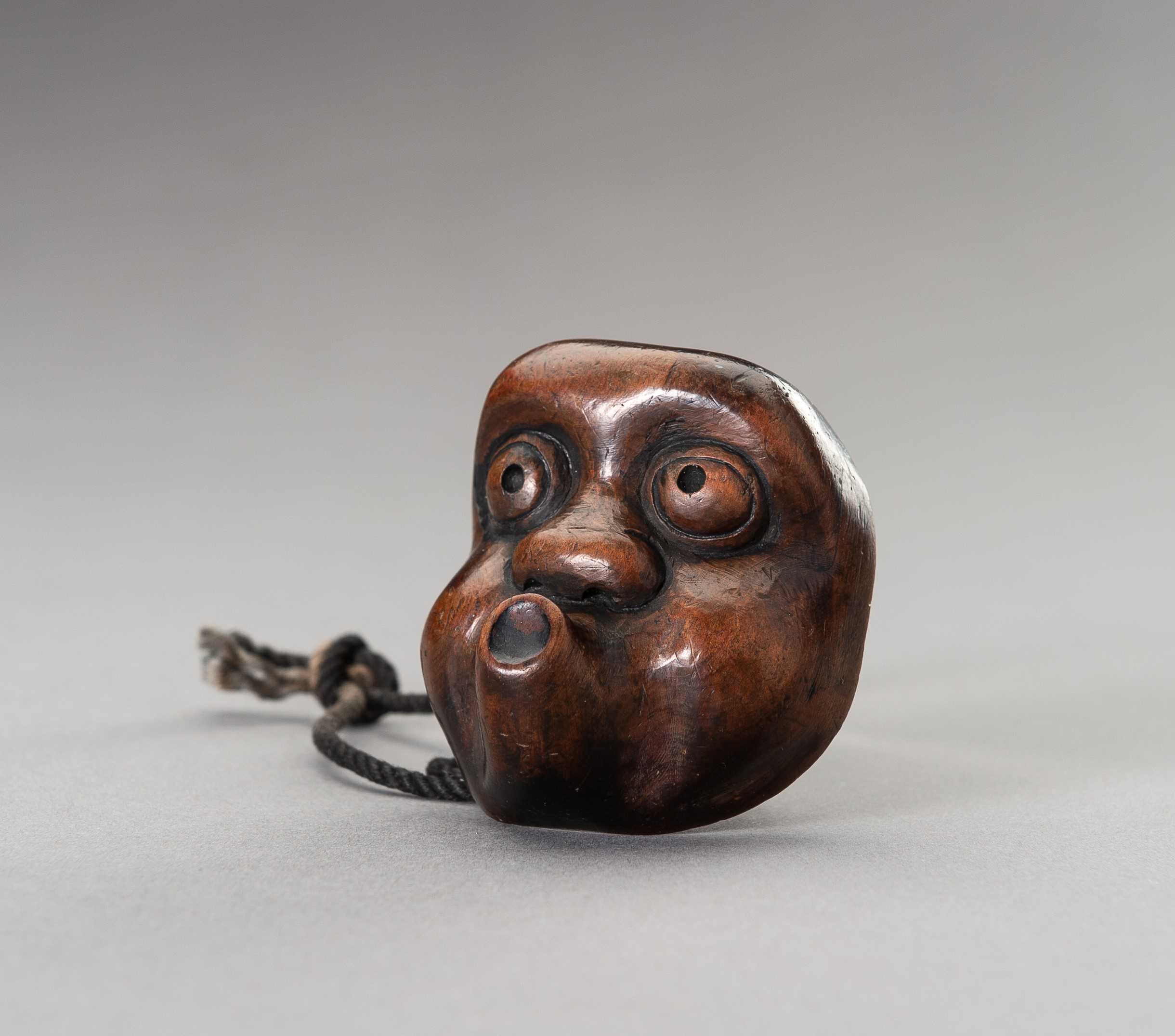 Lot 461 - A LARGE HYOTTOKO MASK WOOD NETSUKE