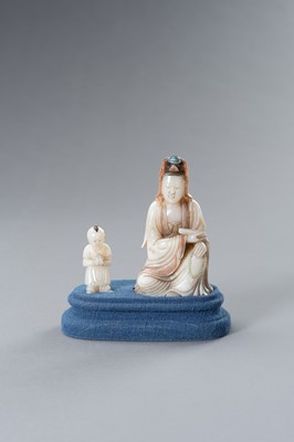 Lot 218 - A SOAPSTONE GROUP OF GUANYIN WITH BOY