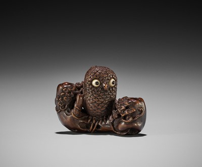 Lot 130 - IKKYU: A WOOD NETSUKE OF AN OWL WITH MOVABLE OWLETS