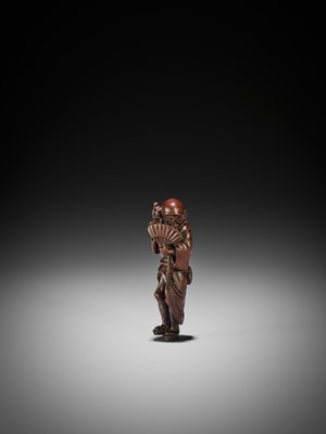 Lot 147 - MINKO: A RARE TALL WOOD NETSUKE OF AN ITINERANT MONK