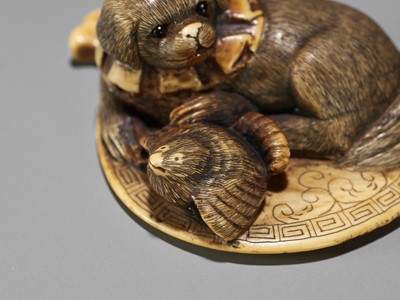 Lot 596 - A STAINED IVORY NETSUKE OF A PUPPY AND A SPARROW