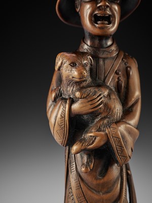 Lot 15 - A VERY LARGE AND SUPERB WOOD NETSUKE OF A FOREIGNER WITH DOG