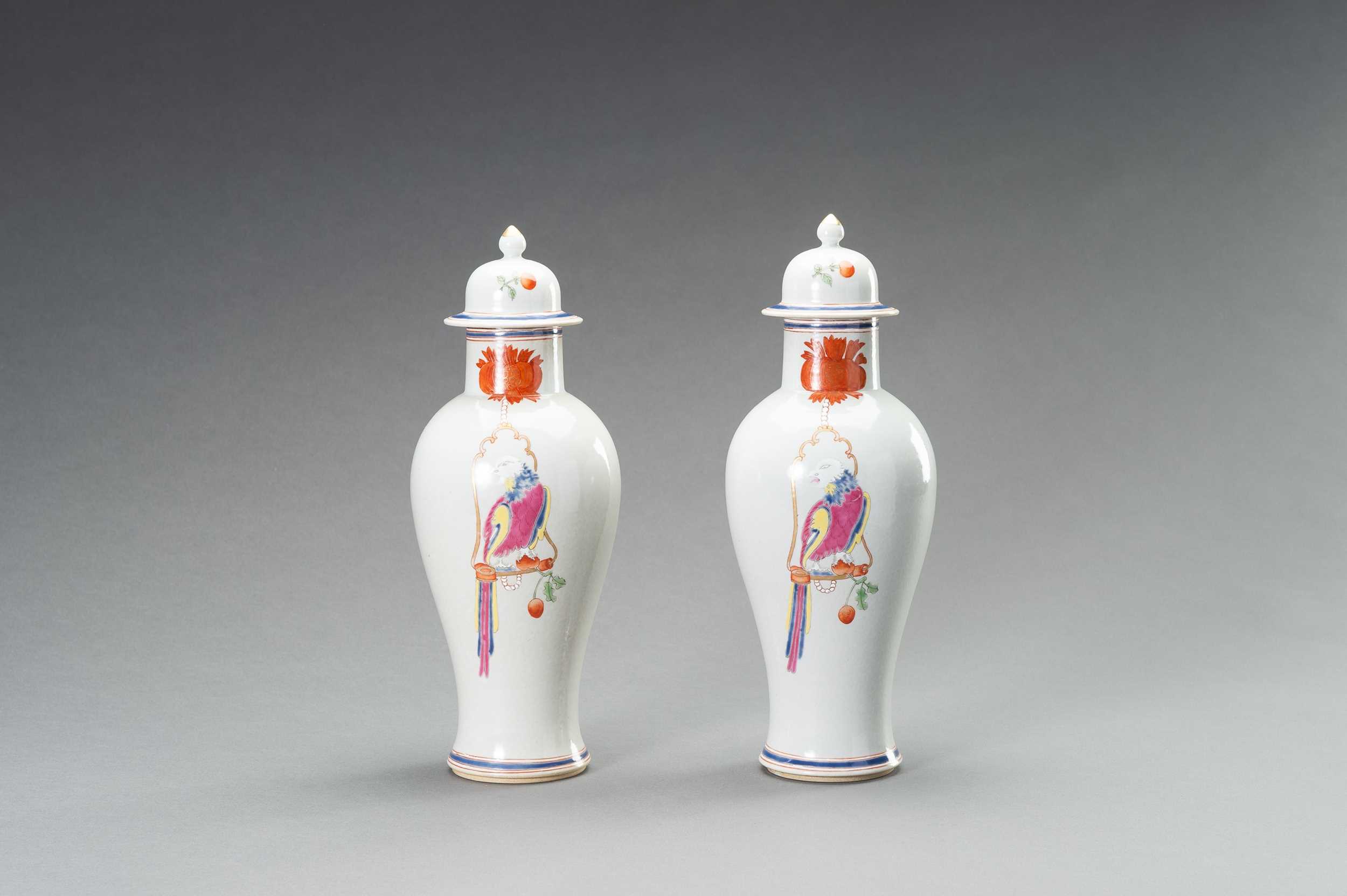 A PAIR OF FAMILLE ROSE ‘PARROT ON PERCH’ BALUSTER VASES, QING