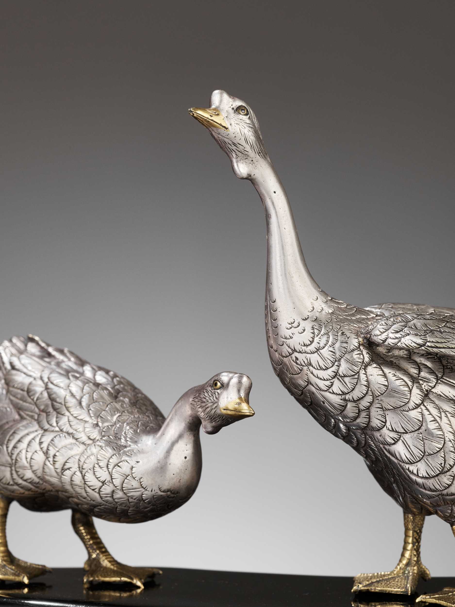 CHIKAYOSHI: A GILT AND SILVERED BRONZE OKIMONO OF TWO GEESE