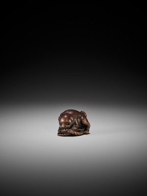 Lot 145 - A WOOD NETSUKE OF A PUPPY PLAYING WITH A SANDAL, ATTRIBUTED TO KOKEI