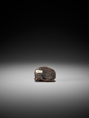 Lot 145 - A WOOD NETSUKE OF A PUPPY PLAYING WITH A SANDAL, ATTRIBUTED TO KOKEI