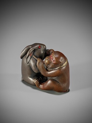 Lot 334 - A RARE LACQUERED NETSUKE OF A MONKEY AND HARE ENGAGED IN KUBIHIKI (NECK WRESTLING)