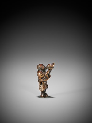 Lot 197 - HOKKYO SESSAI: A WOOD NETSUKE OF A YAMABUSHI BLOWING ON A CONCH