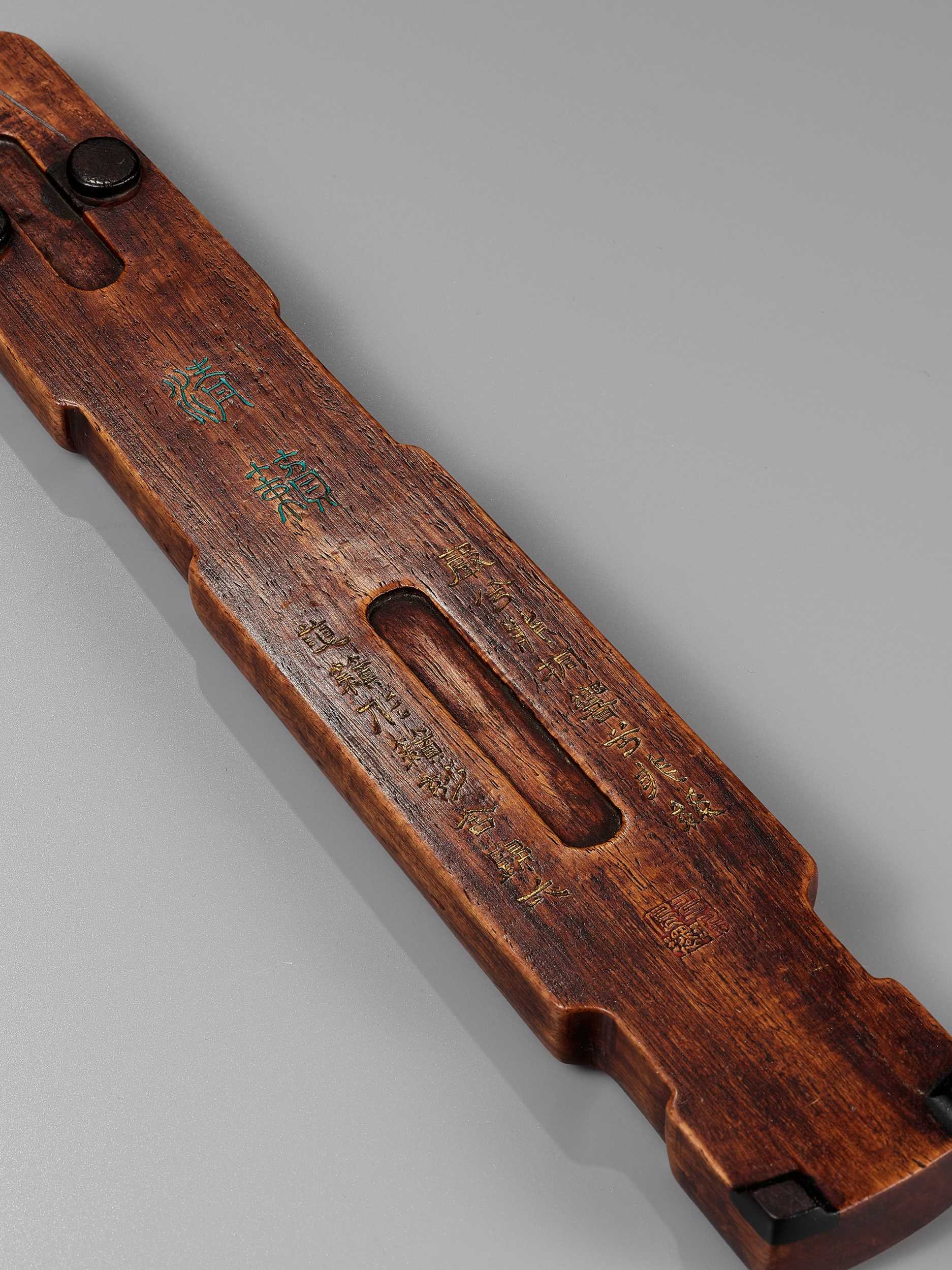 Lot 298 A WOOD ‘QIN’ WRIST REST, QING DYNASTY