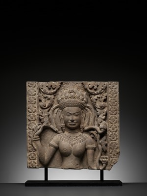 Lot 570 - A SANDSTONE RELIEF OF AN APSARA, BAYON STYLE, ANGKOR PERIOD