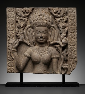 Lot 570 - A SANDSTONE RELIEF OF AN APSARA, BAYON STYLE, ANGKOR PERIOD