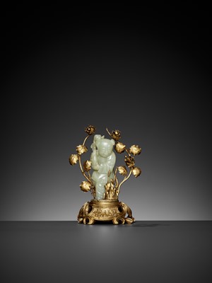 Lot 458 - A CELADON JADE FIGURE OF A BOY MOUNTED ON A GILT BRONZE STAND, QING DYNASTY