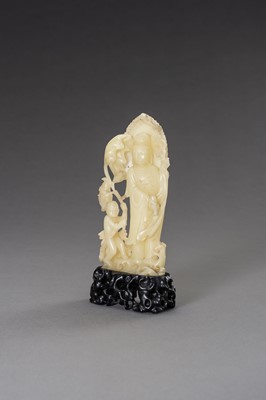 Lot 171 - A CARVED SOAPSTONE FIGURE OF GUANYIN AND CHILD, LATE QING