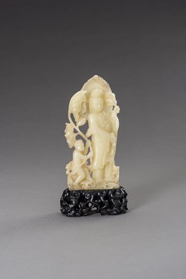 Lot 171 - A CARVED SOAPSTONE FIGURE OF GUANYIN AND CHILD, LATE QING