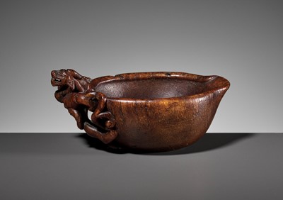 Lot 417 - A RARE RHINOCEROS HORN ‘CHILONG’ POURING VESSEL, YI, LATE MING TO EARLY QING DYNASTY