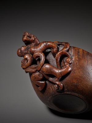 Lot 417 - A RARE RHINOCEROS HORN ‘CHILONG’ POURING VESSEL, YI, LATE MING TO EARLY QING DYNASTY