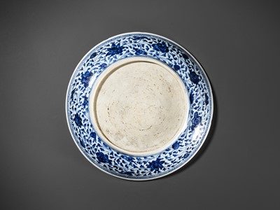 Lot 423 - A MING-STYLE BLUE AND WHITE 'LOTUS BOUQUET' DISH, 18TH CENTURY