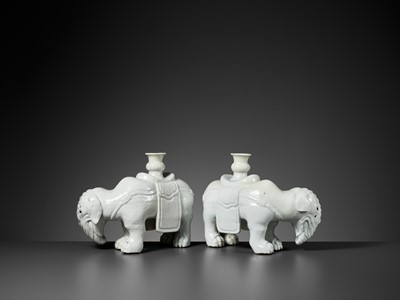 Lot 197 - A DEHUA PAIR OF ELEPHANT CANDLE-HOLDERS, EARLY QING DYNASTY