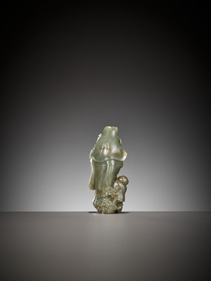 Lot 354 - A DEEP CELADON AND RUSSET JADE ‘GUANYIN AND SHANCAI’ GROUP, QING DYNASTY