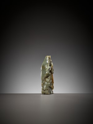 Lot 354 - A DEEP CELADON AND RUSSET JADE ‘GUANYIN AND SHANCAI’ GROUP, QING DYNASTY