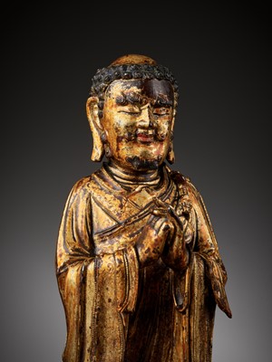 Lot 386 - A RARE GILT BRONZE FIGURE OF A BUDDHIST DISCIPLE, POSSIBLY ANANDA, MING DYNASTY