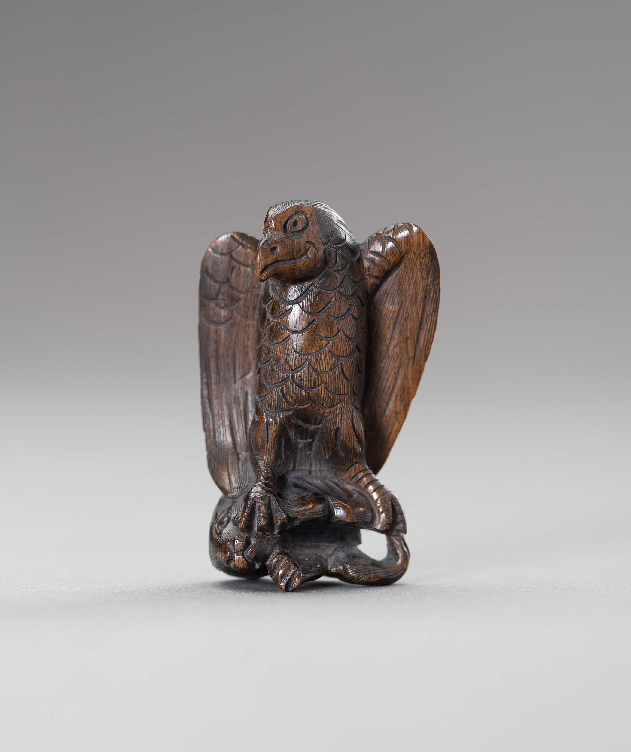 Lot 508 - A WOOD NETSUKE OF AN EAGLE SNATCHING A RABBIT