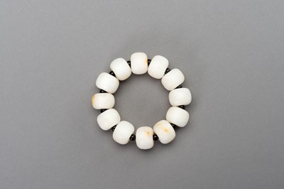 Lot 260 - A WHITE AND RUSSET JADE BRACELET, 20th CENTURY