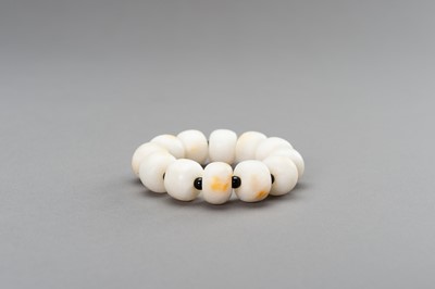 Lot 260 - A WHITE AND RUSSET JADE BRACELET, 20th CENTURY