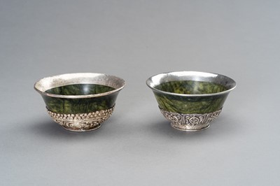 Lot 220 - A PAIR OF SILVER MOUNTED SPINACH-GREEN JADE BOWLS
