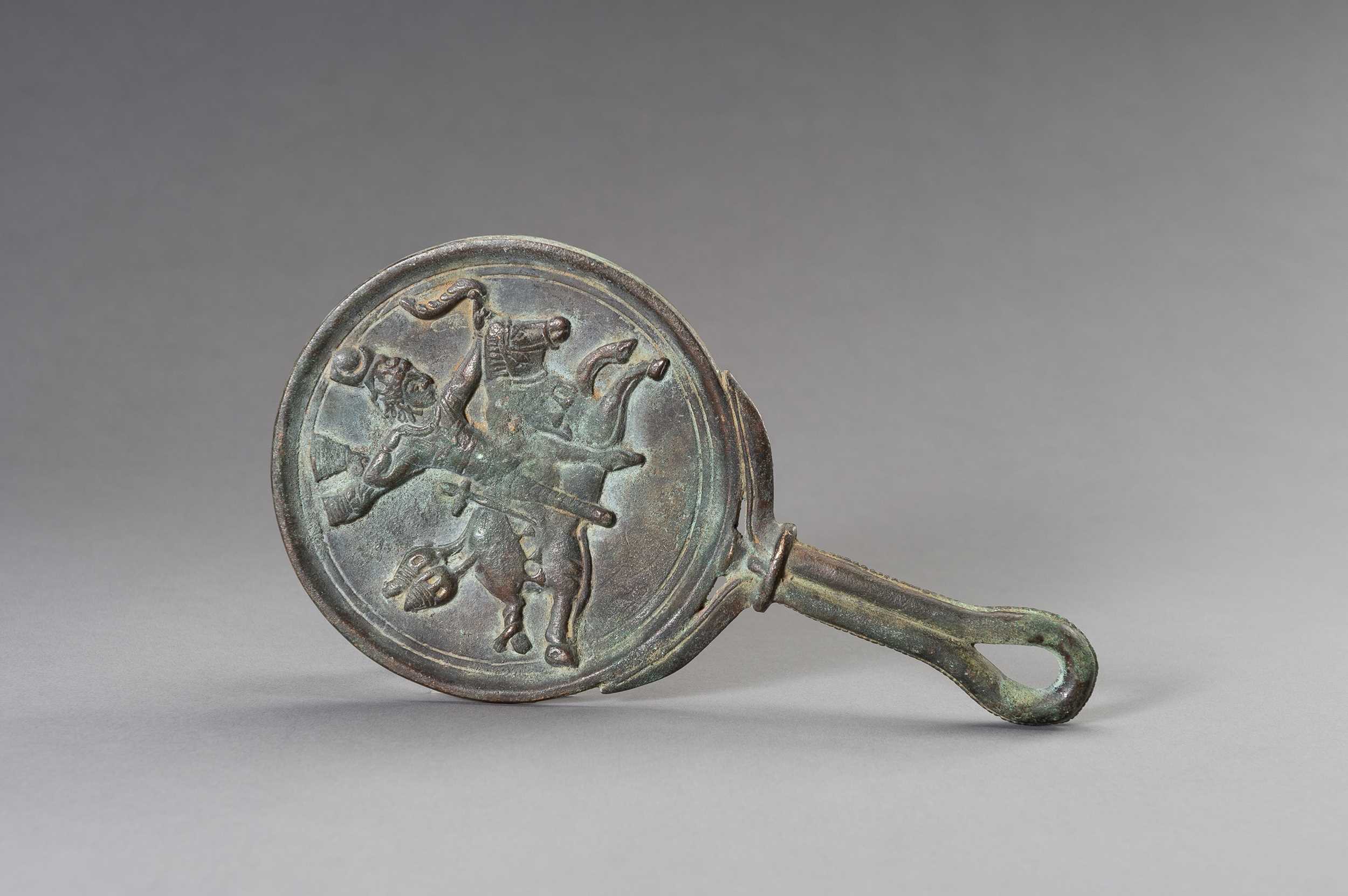Lot 1153 - A MASSIVE GANDHARA STYLE BRONZE MIRROR WITH A FIGURAL SCENE