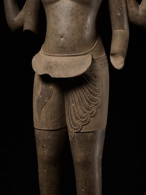 Lot 268 - AN EXTREMELY RARE AND MONUMENTAL SANDSTONE STATUE OF VISHNU, ANGKOR PERIOD