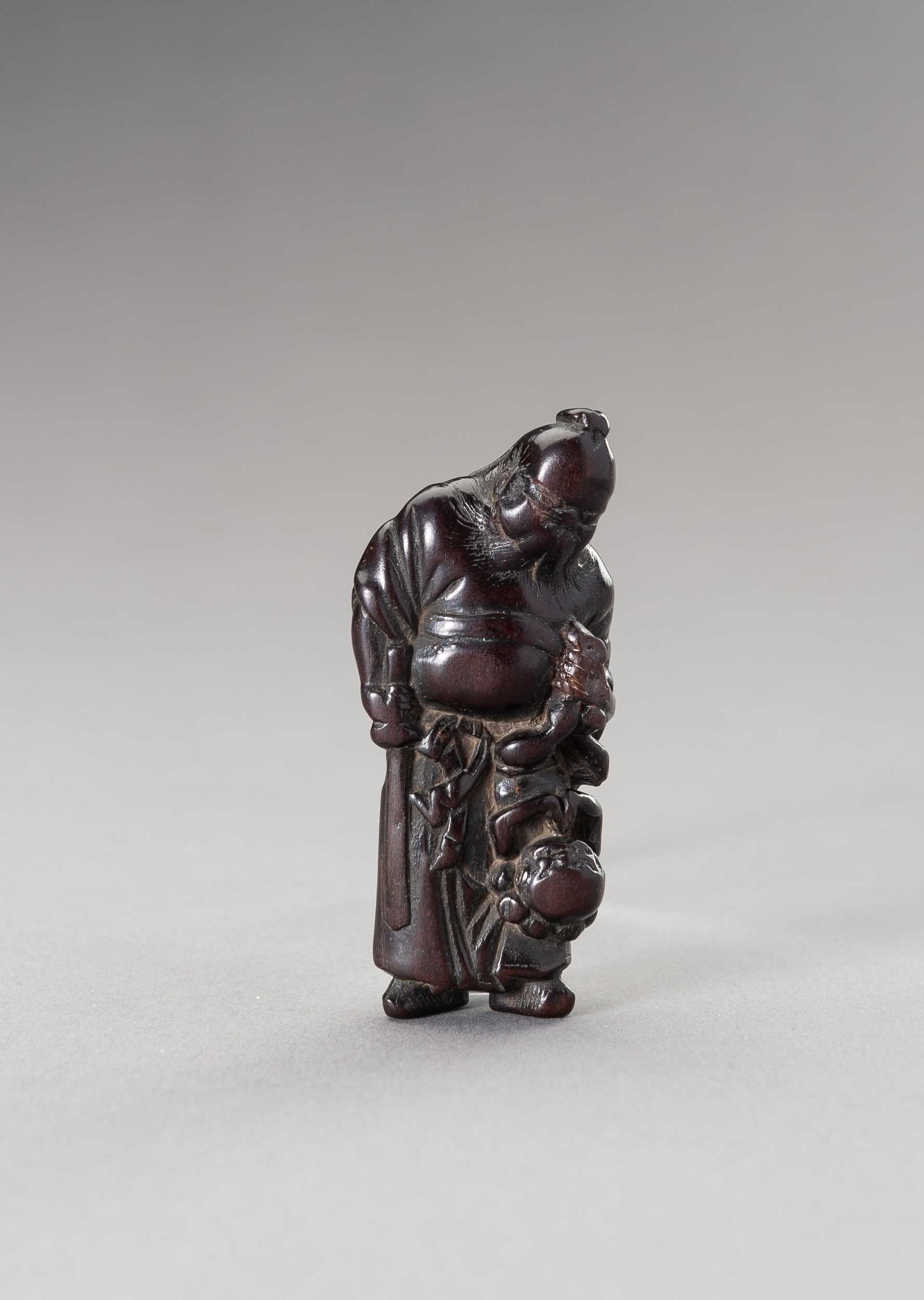 Lot 510 - A WOOD NETSUKE OF SHOKI AND ONI