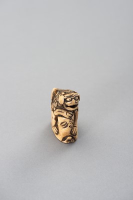 Lot 493 - A STAG ANTLER NETSUKE OF A SHISHI ON A ROCK