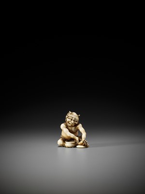 Lot 84 - MASAKA: A SUPERB IVORY NETSUKE OF AN ONI APPLYING MOXA