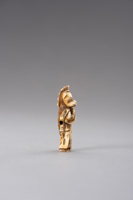 Lot 521 - AN IVORY NETSUKE OF A KYOGEN ACTOR WITH FOX MASK