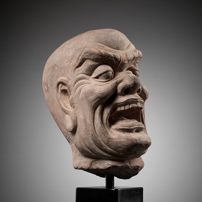 Lot 165 - A RED SANDSTONE HEAD OF A LOKAPALA, SONG TO MING DYNASTY