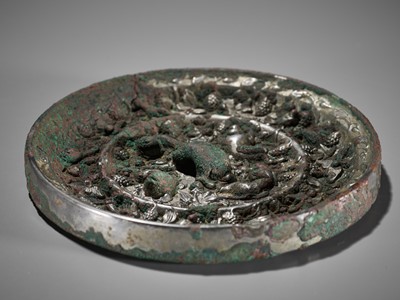 Lot 4 - A SILVERED BRONZE ‘LION AND GRAPEVINES’ MIRROR, TANG DYNASTY