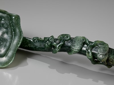 Lot 180 - A SPINACH-GREEN JADEITE ‘LINGZHI AND THREE FRIENDS OF WINTER’ RUYI SCEPTER, 19TH CENTURY