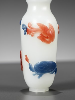Lot 617 - A TWO-COLOR OVERLAY ‘FOUR GUARDIANS’ WHITE GLASS SNUFF BOTTLE, 19TH CENTURY