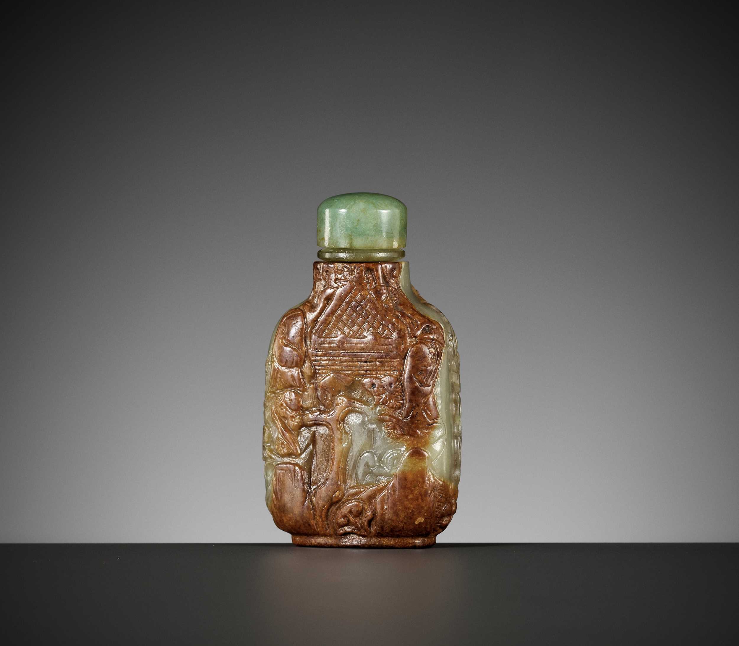 Lot 62 - A CARVED CELADON AND RUSSET JADE SNUFF BOTTLE, MASTER OF THE ROCKS SCHOOL, 1740-1850